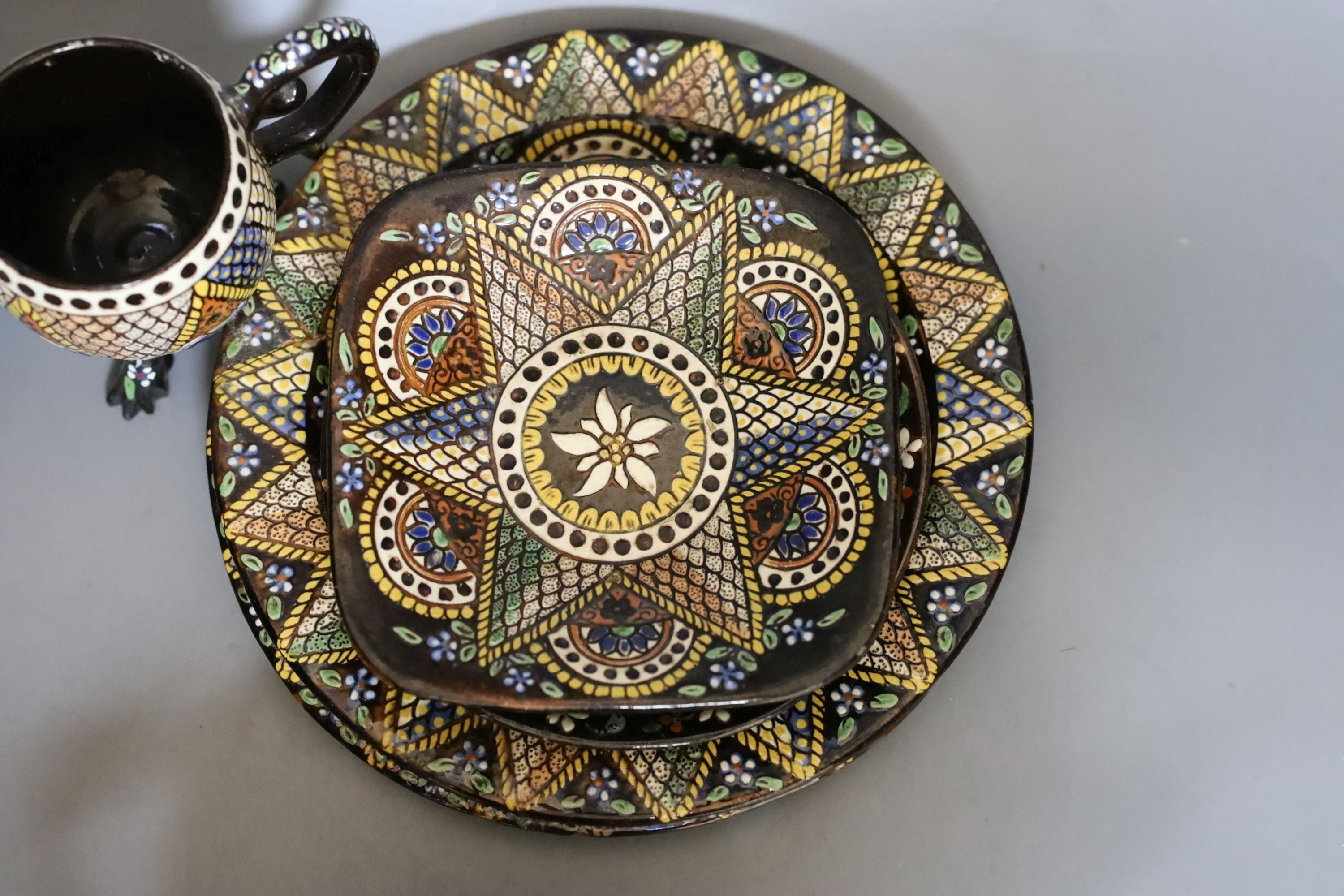 A Swiss Thoune treacle glazed incised pottery tea set, with coloured decoration (8)